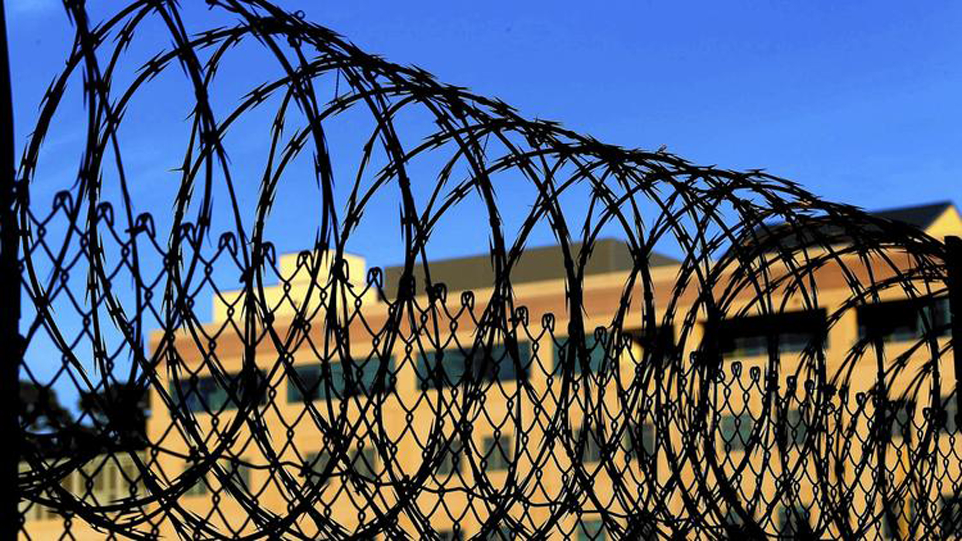 Razor wire encircles the exercise yard at San Quentin. Federal courts have ruled that it is unconstitutional to execute people who are not aware of what is happening to them. Some analysts see irony in providing for the long-term mental health of those sentenced to die. (Los Angeles Times)