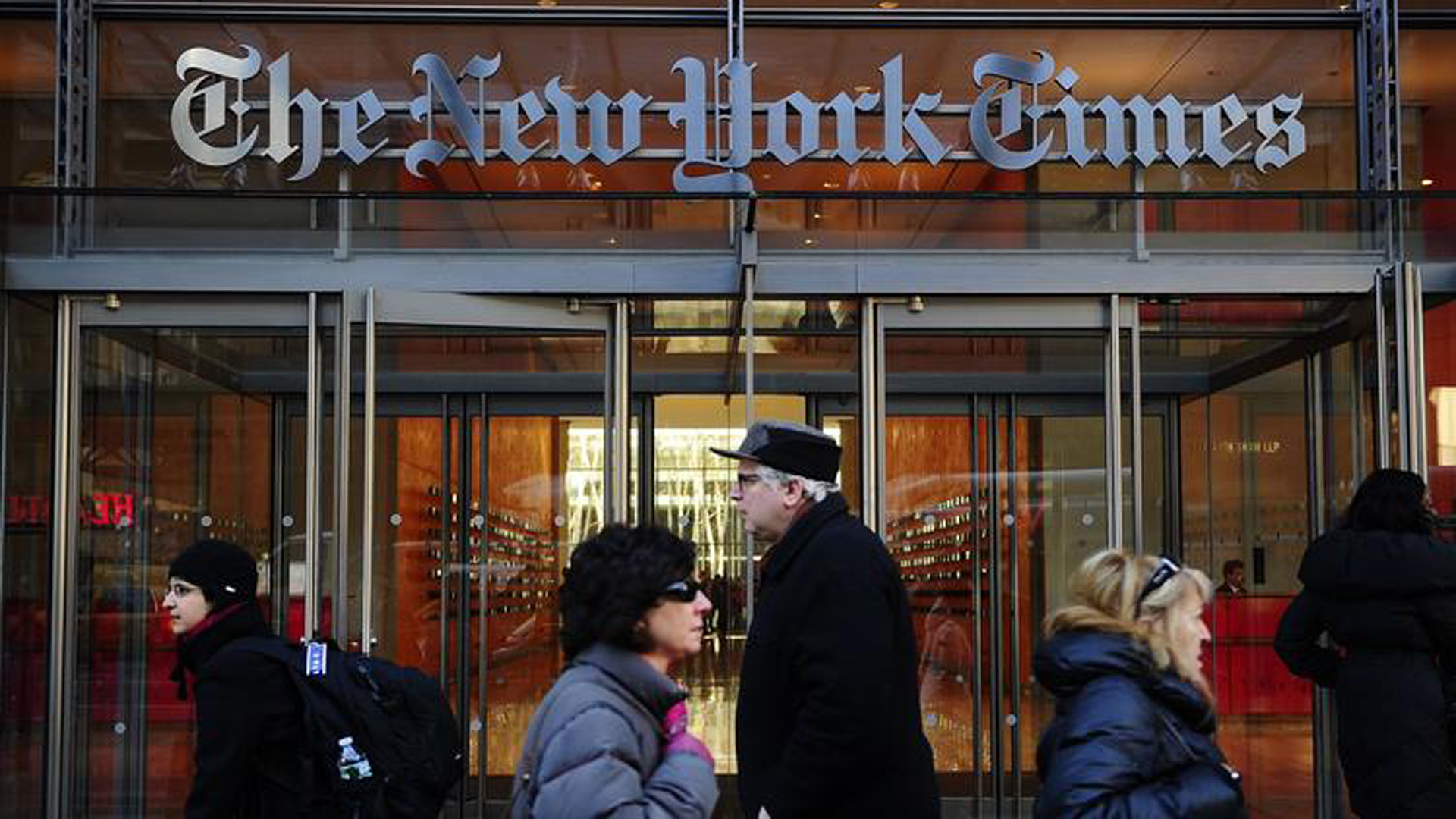 People walk by an entrance to the New York Times on March 8, 2011. (Los Angeles Times)