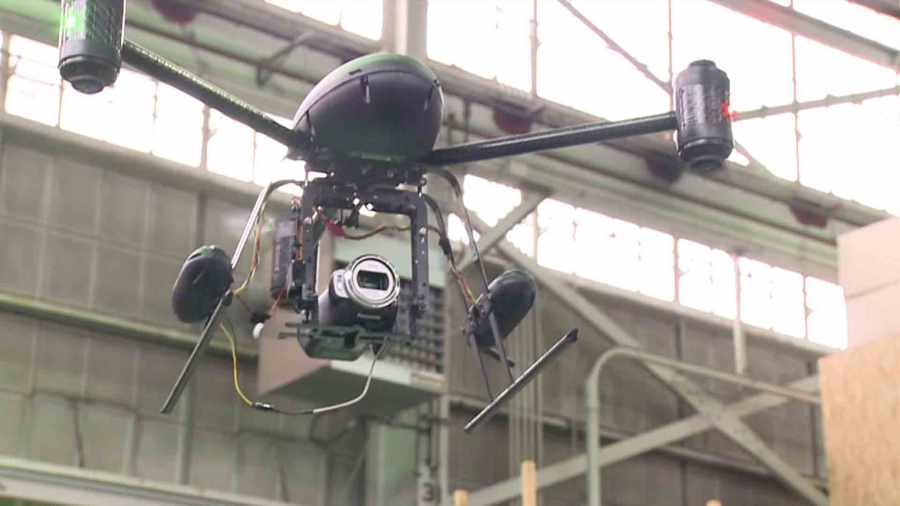 A still from a video shows Seattle police officers using a drone. The Seattle department gave its drones to LAPD in May 2014 amid controversy. (Credit: KCPQ)