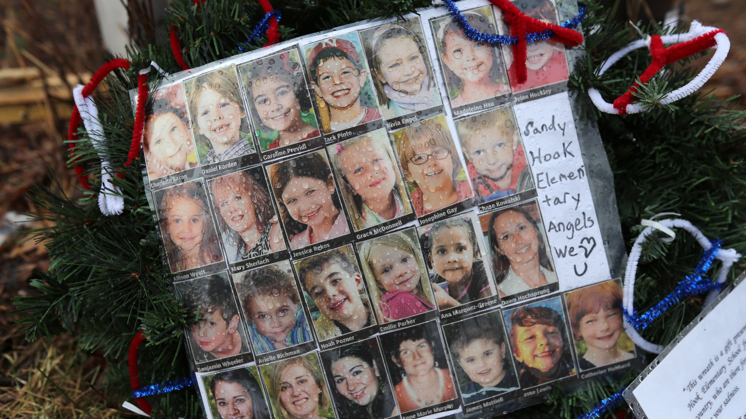 Photos of Sandy Hook Elementary School massacre victims sits at a small memorial near the school on Monday, Jan. 14, 2013, in Newtown, Connecticut. (Credit: John Moore/Getty Images)