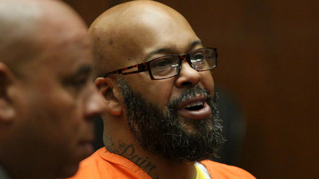 Former rap mogul Marion "Suge" Knight, in orange jail attire, appears with attorney Matthew Fletcher in Los Angeles criminal court April 8, 2015. (Credit: Irfan Khan / Los Angeles Times)