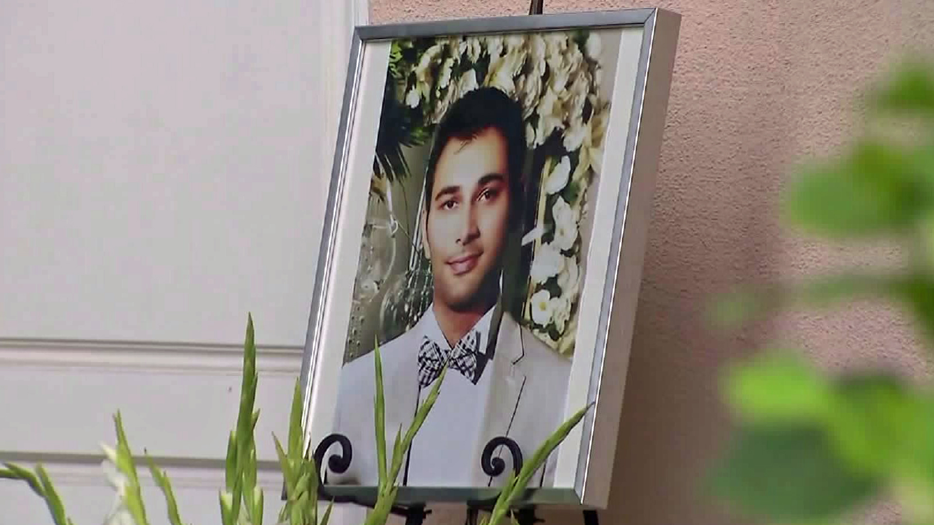 A photo of Shayan Mazroei is seen outside a Laguna Niguel home, where a vigil was held in his honor on Sept. 12, 2015. (Credit: KTLA)