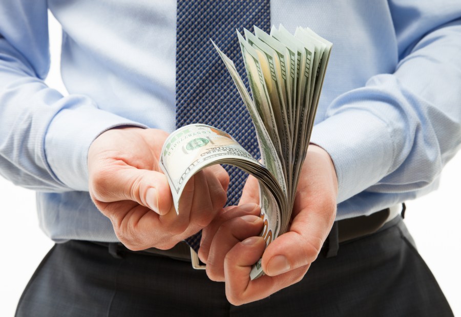 Man's hands holding dollar banknotes