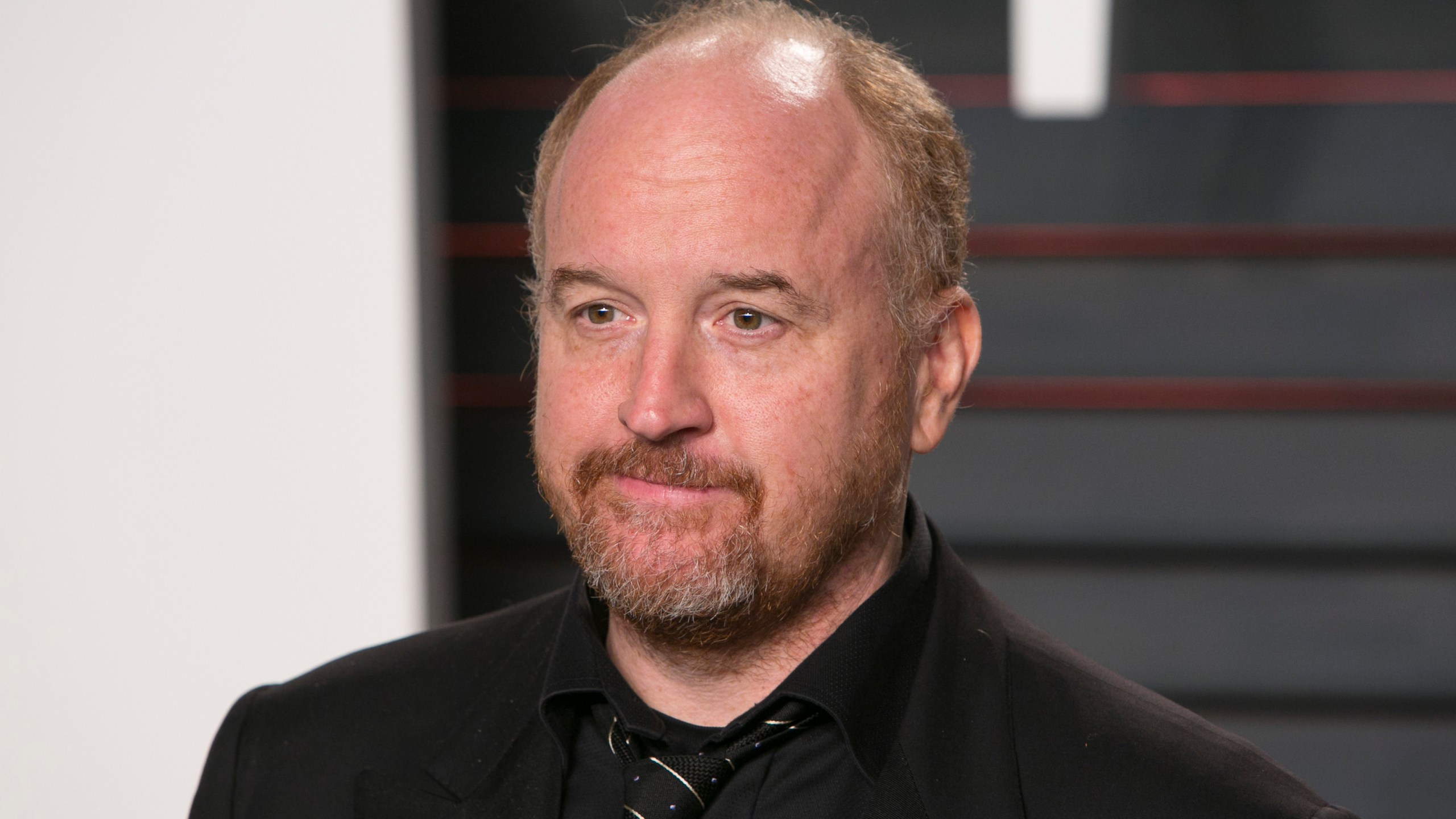 Comedian Louis C.K. poses as he arrives to the 2016 Vanity Fair Oscar Party in Beverly Hills on Feb. 28, 2016. (Credit: Adrian Sanchez Gonzalez/AFP/Getty Images)