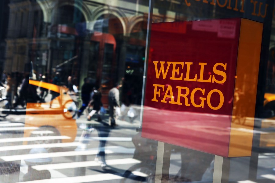 Pedestrians pass a Wells Fargo bank branch in lower Manhattan on April 15, 2016, in New York City. (Credit: Spencer Platt / Getty Images)