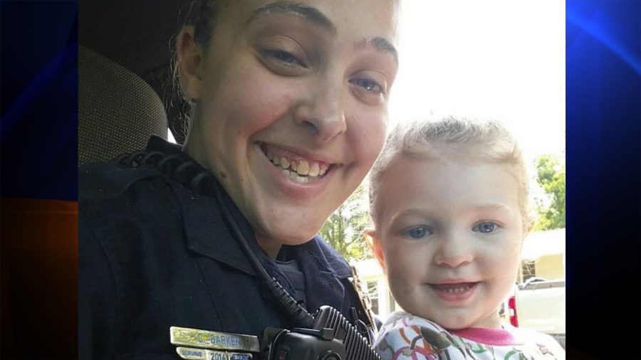 Officer Cassie Barker is shown in a photo with her daughter. (Credit: WLOX Facebook)