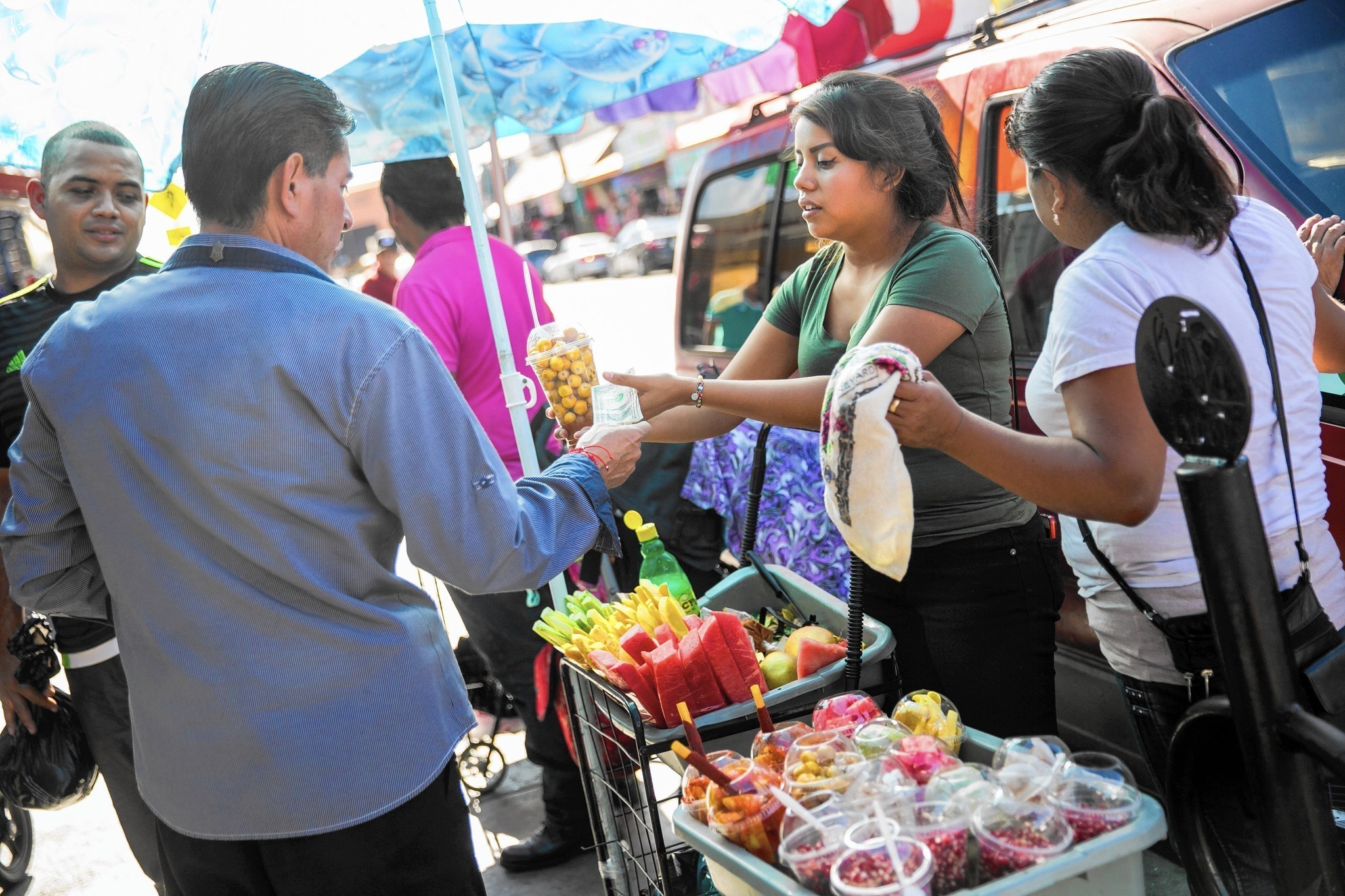 A street vendor sell fruits and in the Fashion District in Los Angeles in an undated photo. (Credit: Marcus Yam / Los Angeles Times)