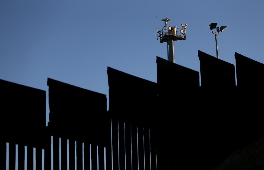 Surveillance cameras stand above the U.S.-Mexican border fence at Playas de Tijuana on Jan. 27, 2017, in Tijuana, Mexico. (Credit: Justin Sullivan/Getty Images)