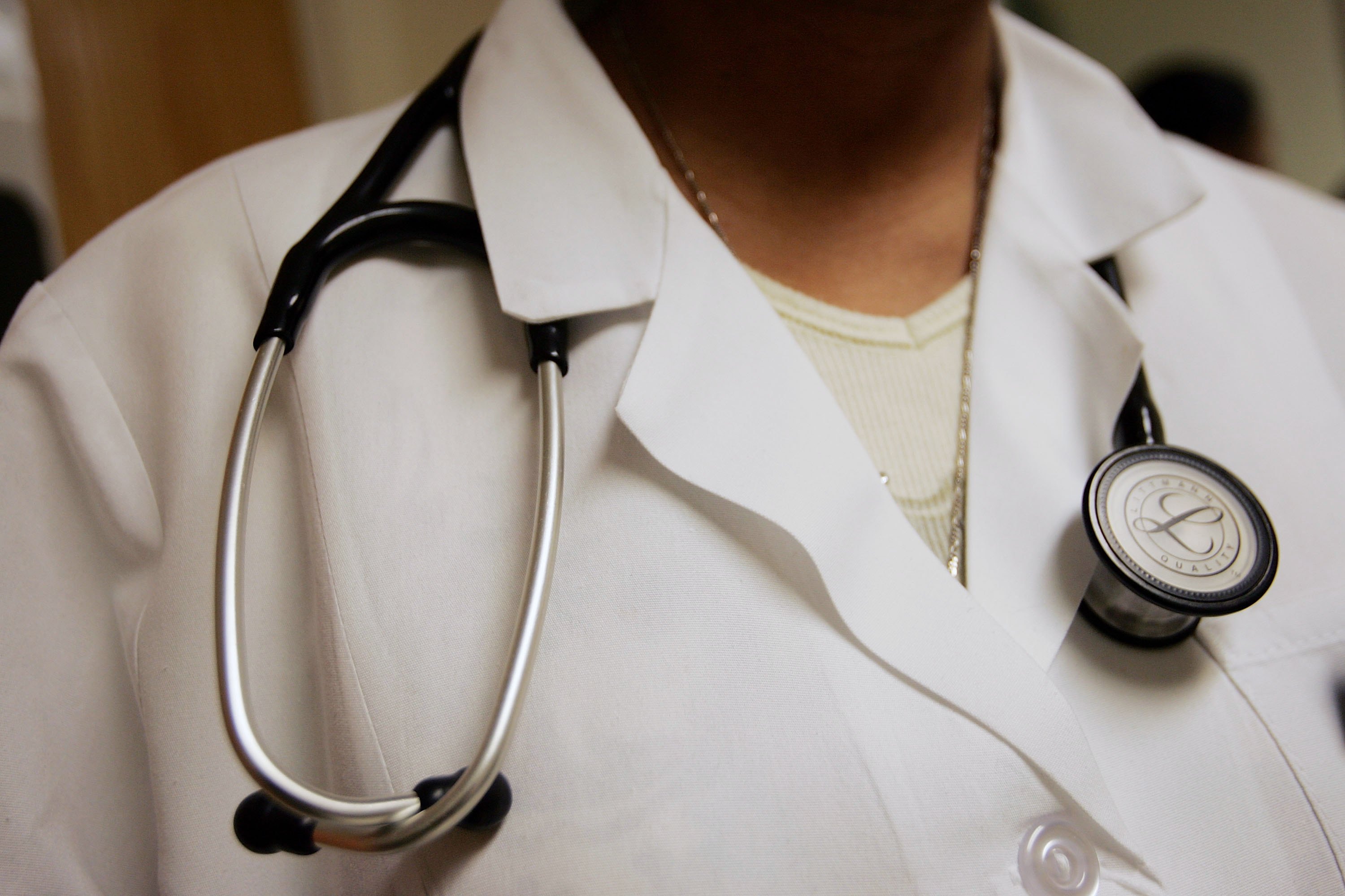 Dominique Entzminger, a physician assistant of family medicine, wears a stethoscope during an examination at the Codman Square Health Center April 5, 2006, in Dorchester, Massachusetts. (Credit: Joe Raedle/Getty Images)