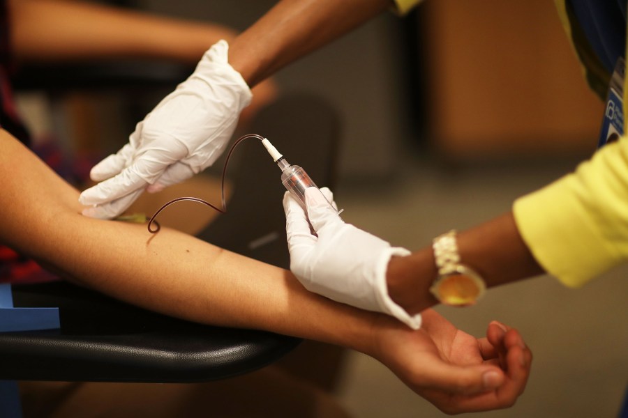 Peter Yanez, who is insured under a policy from the Affordable Care Act, has blood drawn by Linda Williams, a medical assistant, as he gets a blood test at a Planned Parenthood health center on May 12, 2017 in Miami. (Credit: Joe Raedle/Getty Images)