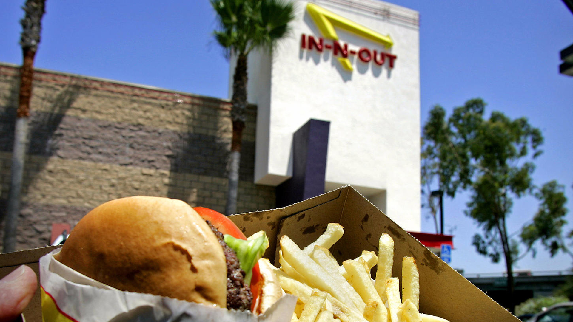 An In-N-Out burger and fries is seen in front of one of its stores in this file photo. (Credit: Los Angeles Times)