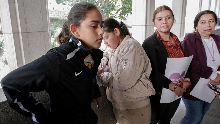 Fatima Avelica, left, with sister Yuleni, mother Norma and aunt Martina Avelica earlier this month at L.A. Superior Court to support her father, Romulo Avelica-Gonzalez, an immigrant who was detained by ICE agents as he drove her to school in Highland Park. (Credit: Irfan Khan / Los Angeles Times)