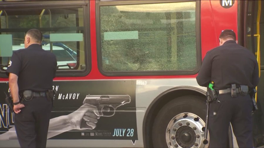 Police are shown on the scene of a bus window shattered by a gunshot in South L.A. on August 3, 2017. (Credit: KTLA)