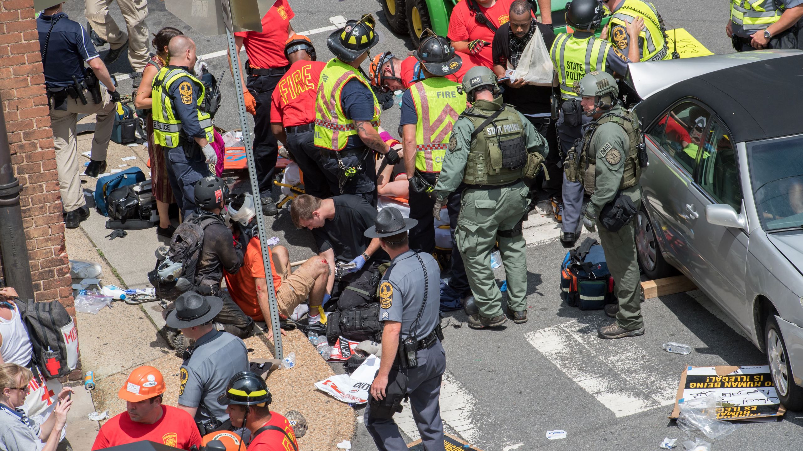 People receive first-aid after a car ran into a crowd of protesters in Charlottesville, Virginia, on Aug. 12, 2017. (Credit: Paul J. Richards / AFP / Getty Images)