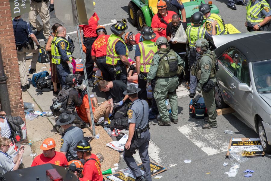 People receive first-aid after a car ran into a crowd of protesters in Charlottesville, Virginia, on Aug. 12, 2017. (Credit: Paul J. Richards / AFP / Getty Images)