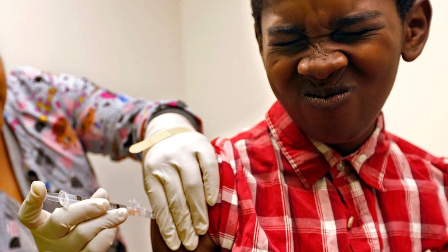 Desmond Sewell, 12, receives his vaccinations by medical assistant Jessica Reyes at the Lou Colen Children's Health and Wellness Center in Mar Vista. (Credit: Genaro Molina / Los Angeles Times)