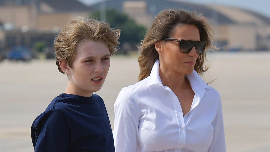 First Lady Melania Trump and son Barron (L) make their way to board Air Force One before departing from Andrews Air Force Base in Maryland on June 30, 2017. (Credit: MANDEL NGAN/AFP/Getty Images)