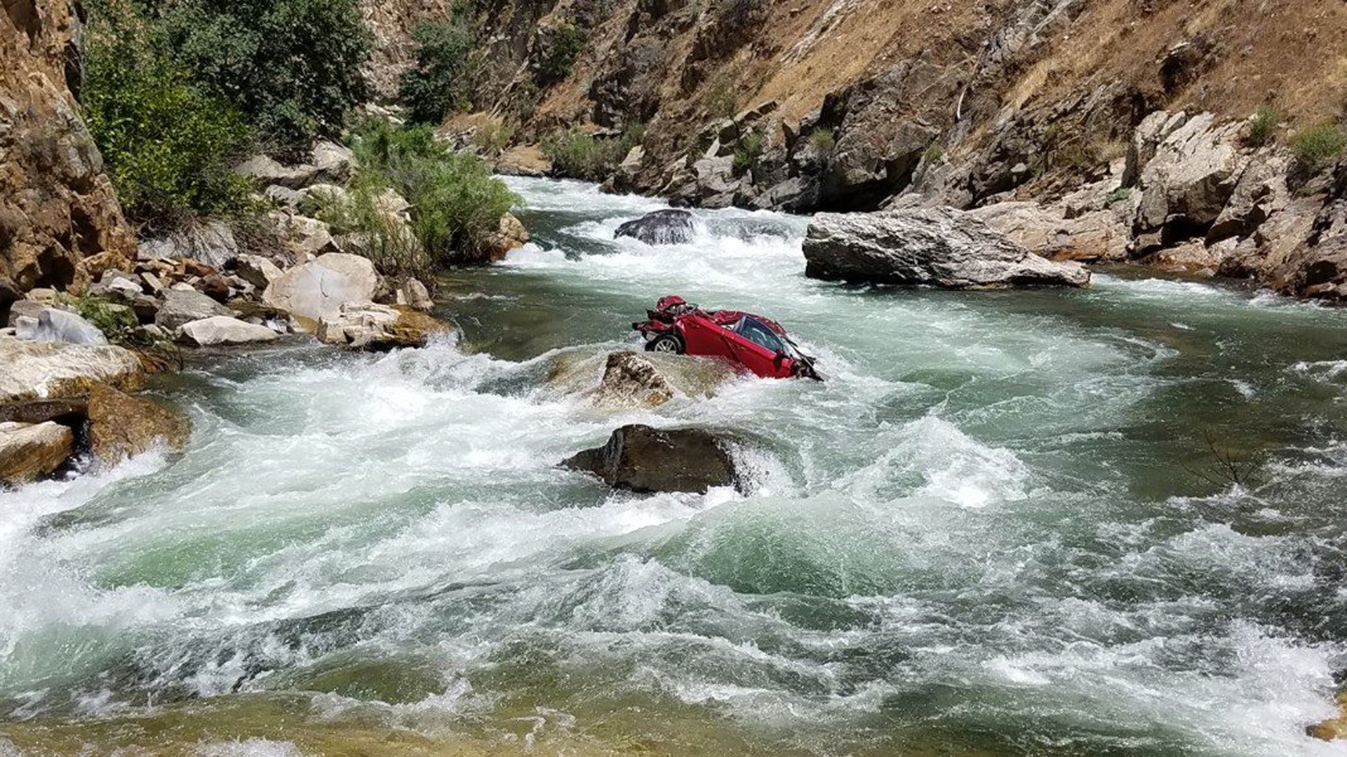 Police in Fresno have been working for two weeks to try and retrieve the vehicle, which is stuck in the middle of a fast-moving part of Kings River. (Credit: Fresno County Sheriff's Office)