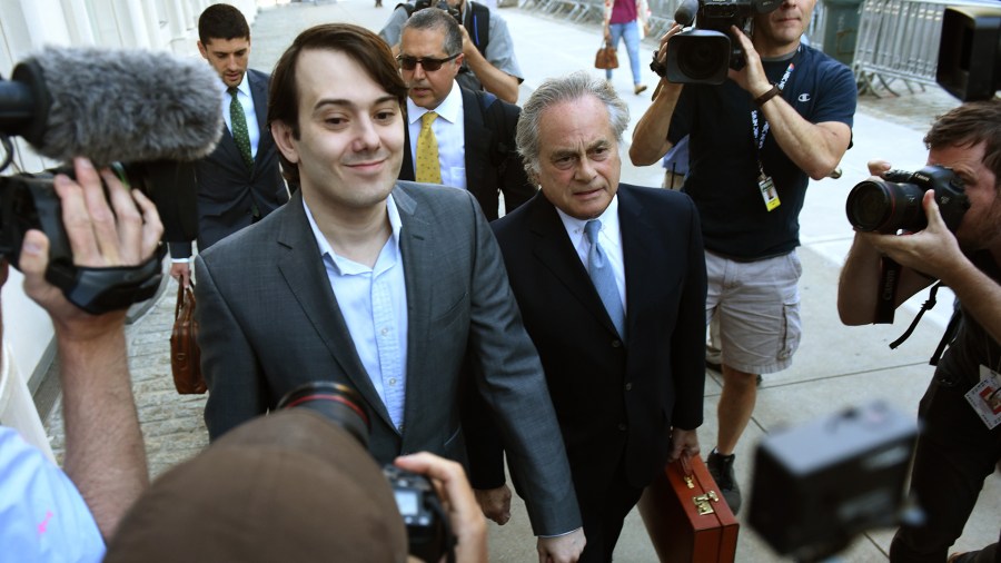 Martin Shkreli, the former Turing Pharmaceuticals executive who became known as "Pharma Bro" arrives for the first day of jury selection in his federal securities fraud trial June 26, 2017, at U.S. District Court Eastern District of New York in Brooklyn. At right is his lawyer Ben Brafman. (Credit: TIMOTHY A. CLARY/AFP/Getty Images)