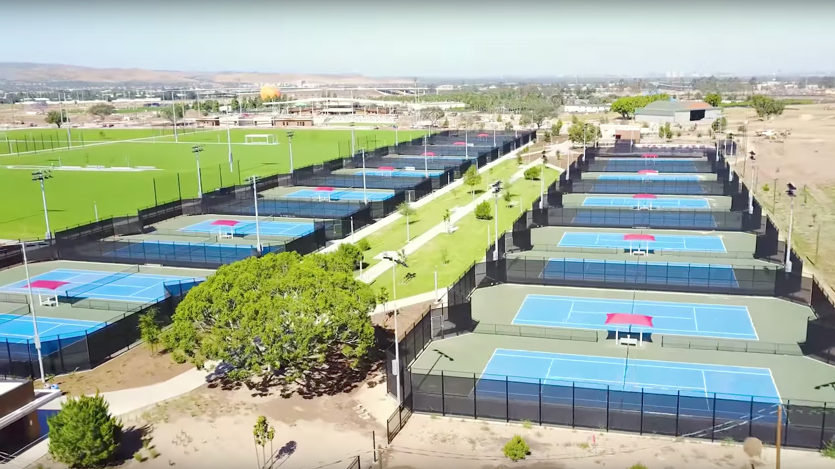 A still from a city of Irvine promotional video of the aerial view of the tennis courts at the Orange County Great Park Sports Park.