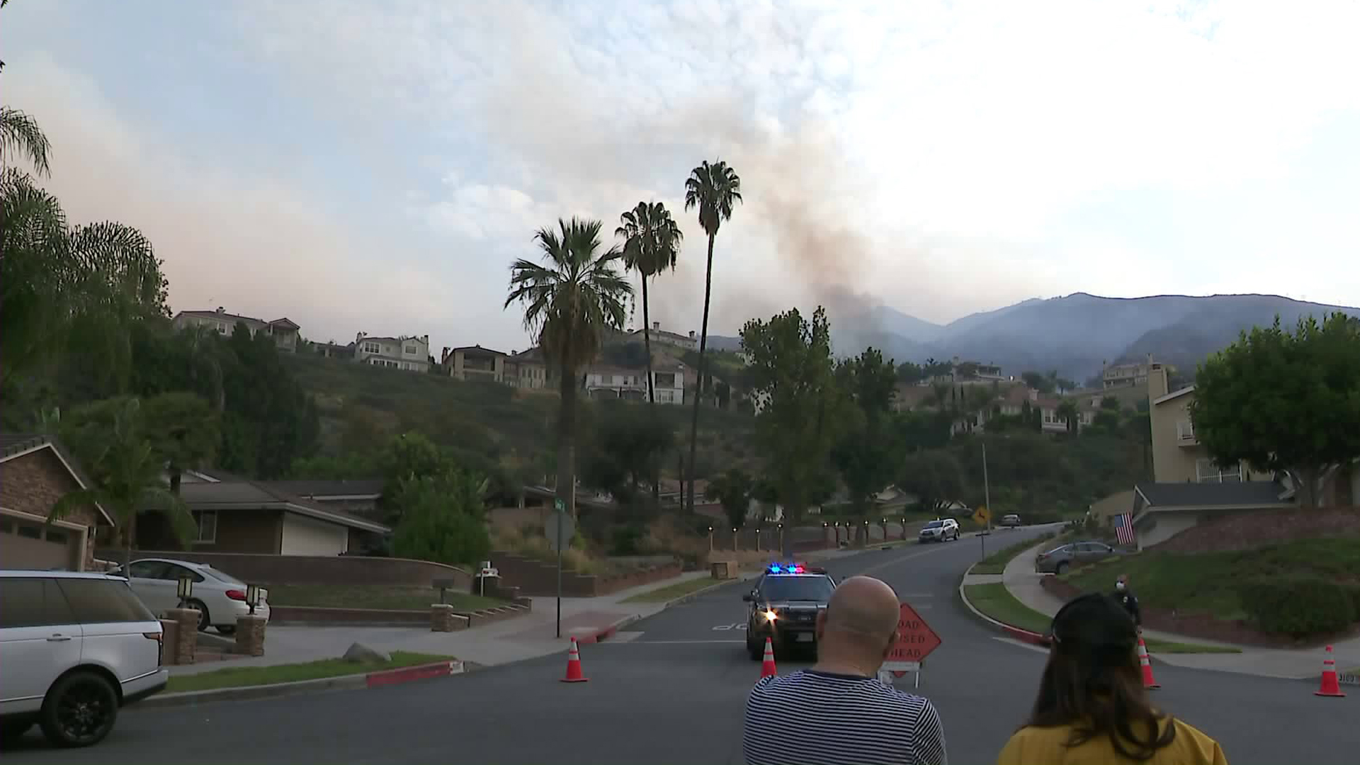 Burbank residents wait near a blocked street to hear if evacuations in their neighborhood are lifted during the La Tuna Fire on Sept. 2, 2017. (Credit: KTLA)