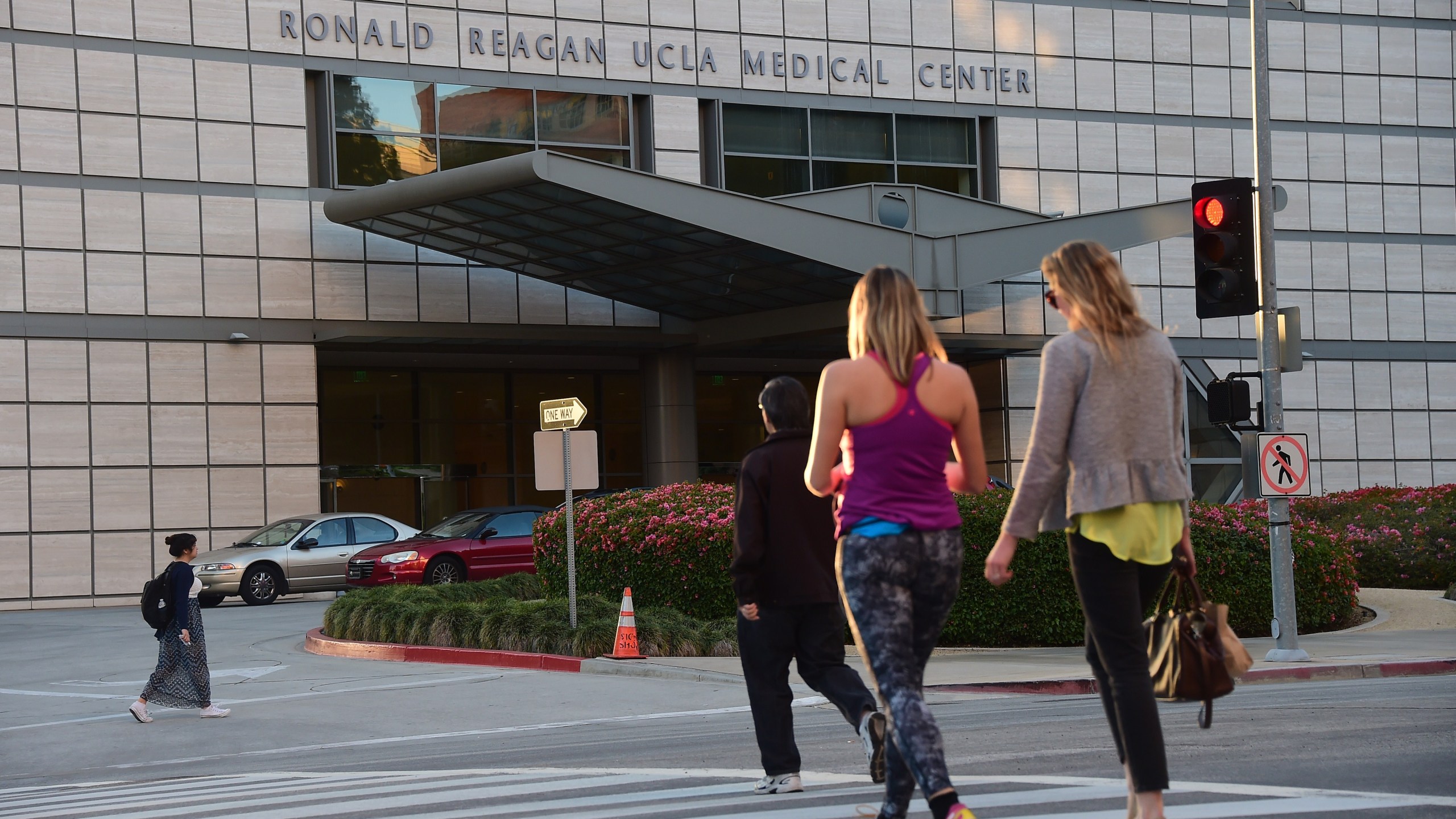 Pedestrians cross the road to the Ronald Reagan UCLA Medical Center on March 5, 2015. (Credit: Frederic J. Brown / AFP / Getty Images)