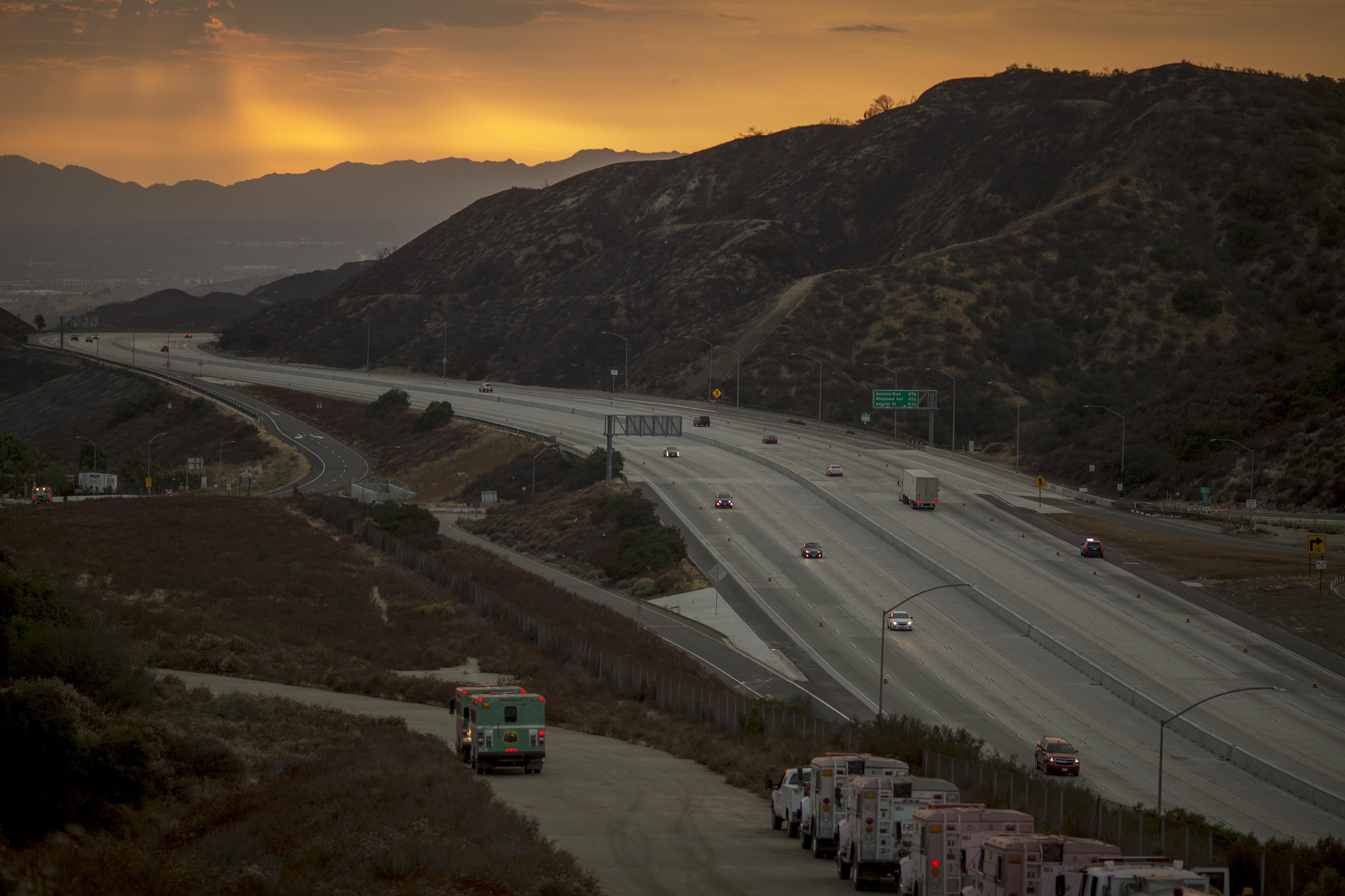 Traffic on the 210 freeway is allowed to resume for the first time since the start of the La Tuna Fire, as light rain showers pass over the burn areas on Sept. 3, 2017. (David McNew / Getty Images)