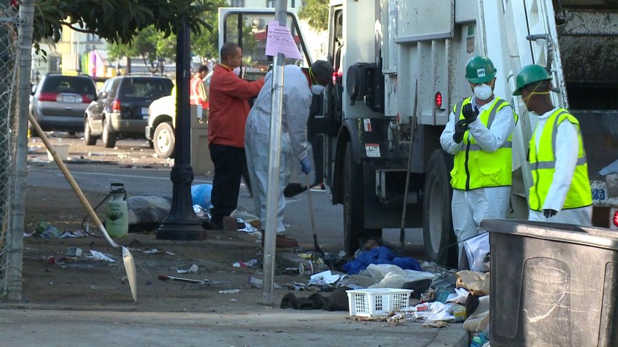 Contract workers in San Diego clean up city streets amid a worsening hepatitis A outbreak. (Credit: KSWB)