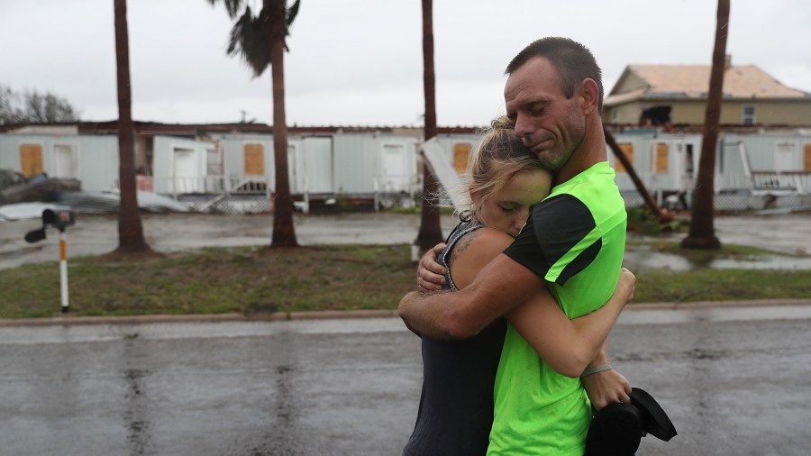 Two people hug after riding out Hurricane Harvey in an apartment on Aug. 26, 2017, in Rockport, Texas. (Credit: Joe Raedle/Getty Images)