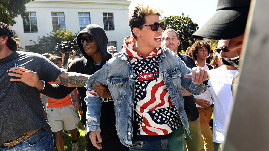 Milo Yiannopoulos is escorted from Sproul Plaza on the UC Berkeley campus after a speech on Sunday. (Credit: Wally Skalij / Los Angeles Times)