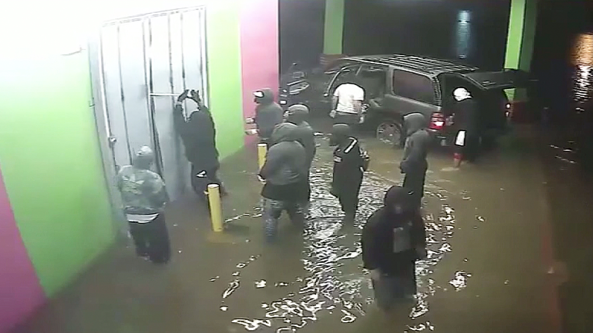 A group of looters can be seen outside a Houston store during Hurricane Harvey. (Credit: Houston Police Department)