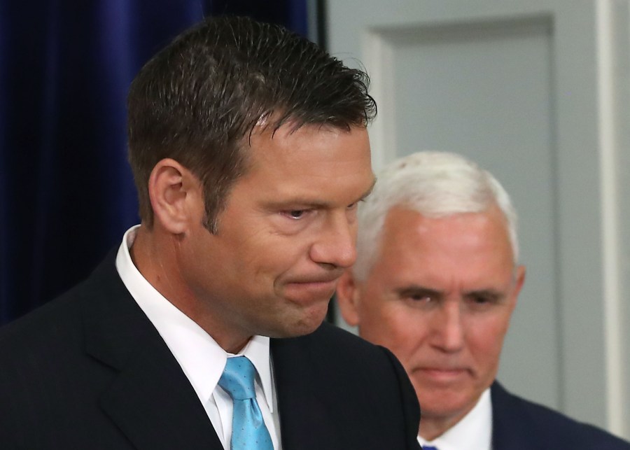 Kansas Secretary of State Kris Kobach, left, and Vice President Mike Pence attend the first meeting of the Presidential Advisory Commission on Election Integrity on July 19, 2017, in Washington, D.C. (Credit: Mark Wilson/Getty Images)