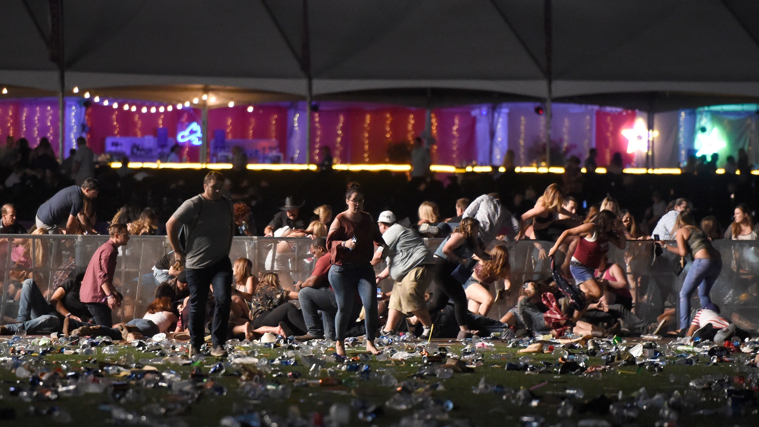 People run from the Route 91 Harvest country music festival after apparent gunfire was heard on Oct. 1, 2017, in Las Vegas. (Credit: David Becker/Getty Images)