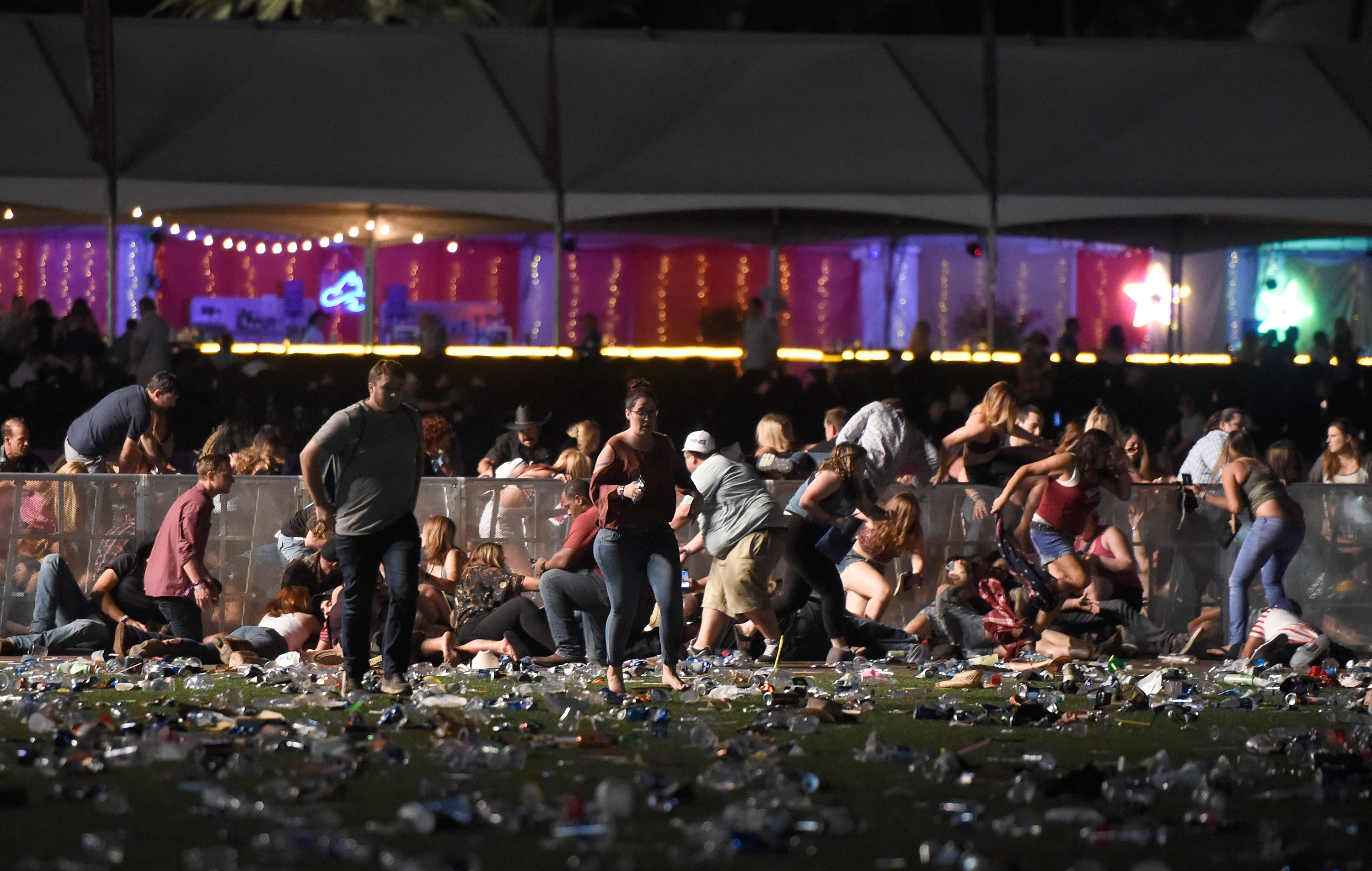 People run from the Route 91 Harvest country music festival after apparent gunfire was heard on Oct. 1, 2017, in Las Vegas. (Credit: David Becker/Getty Images)