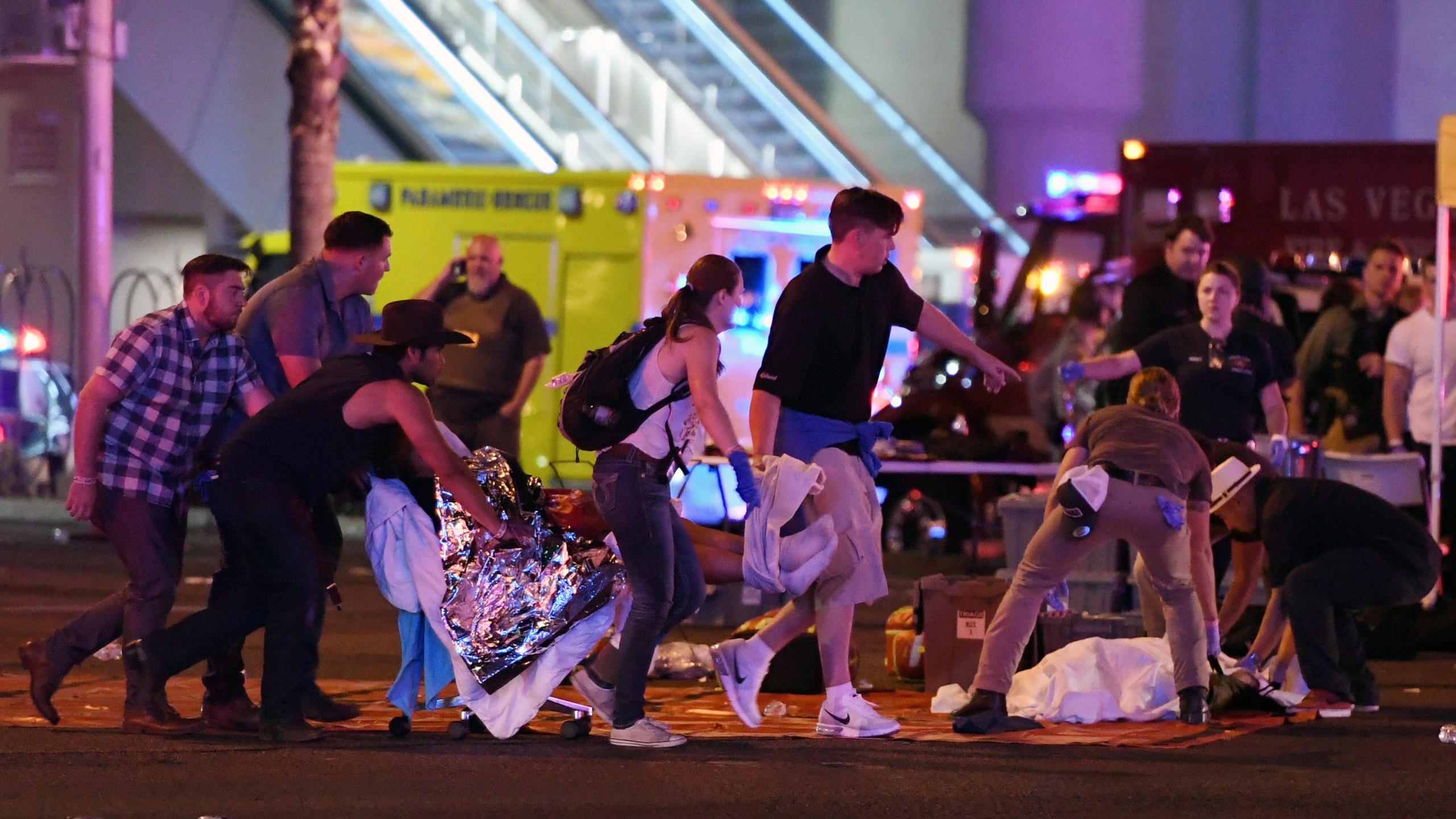 An injured person is tended to in the intersection of Tropicana Ave. and Las Vegas Boulevard after a mass shooting at a country music festival nearby on Oct. 2, 2017 in Las Vegas, Nevada. (Credit: Ethan Miller/Getty Images)