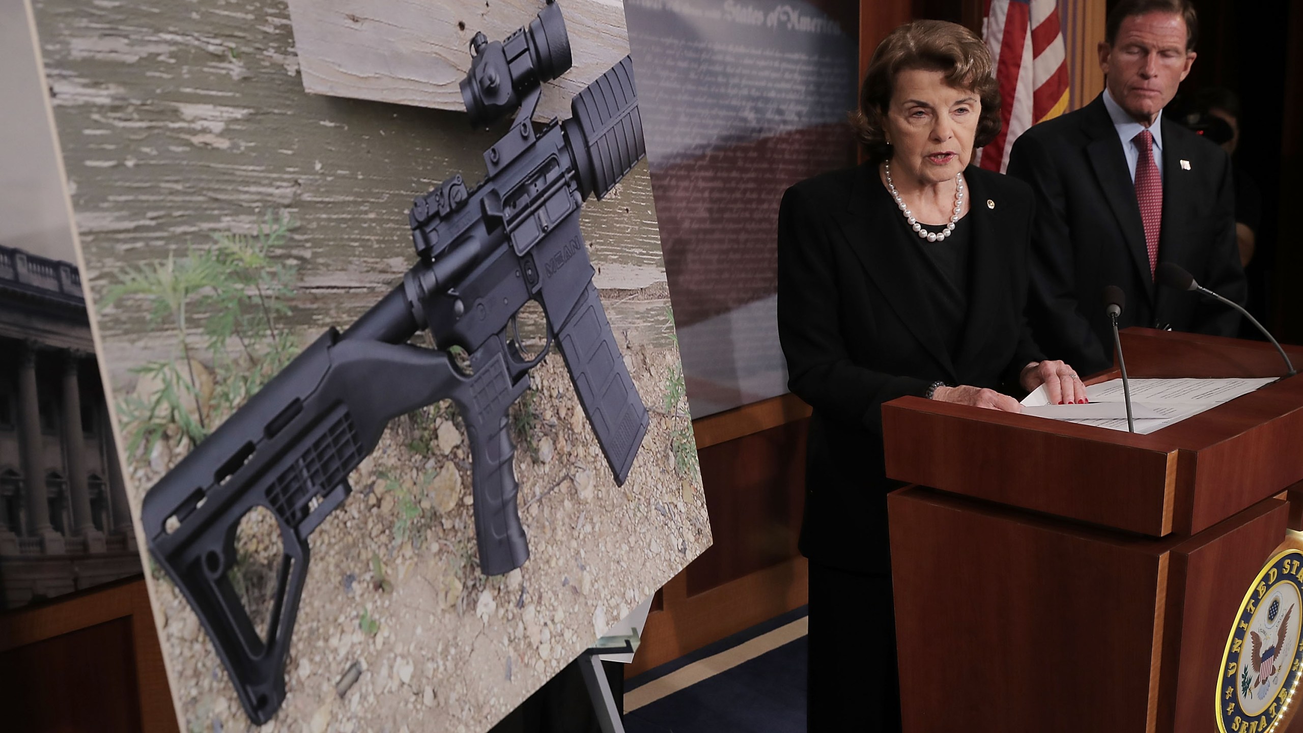 Sen. Dianne Feinstein (D-CA) and Sen. Richard Blumenthal (D-CT) show a photograph of a rifle with a 'bump stock' during a news conference to announce proposed gun control legislation at the U.S. Capitol October 4, 2017 in Washington, DC. (Credit: Chip Somodevilla/Getty Images)