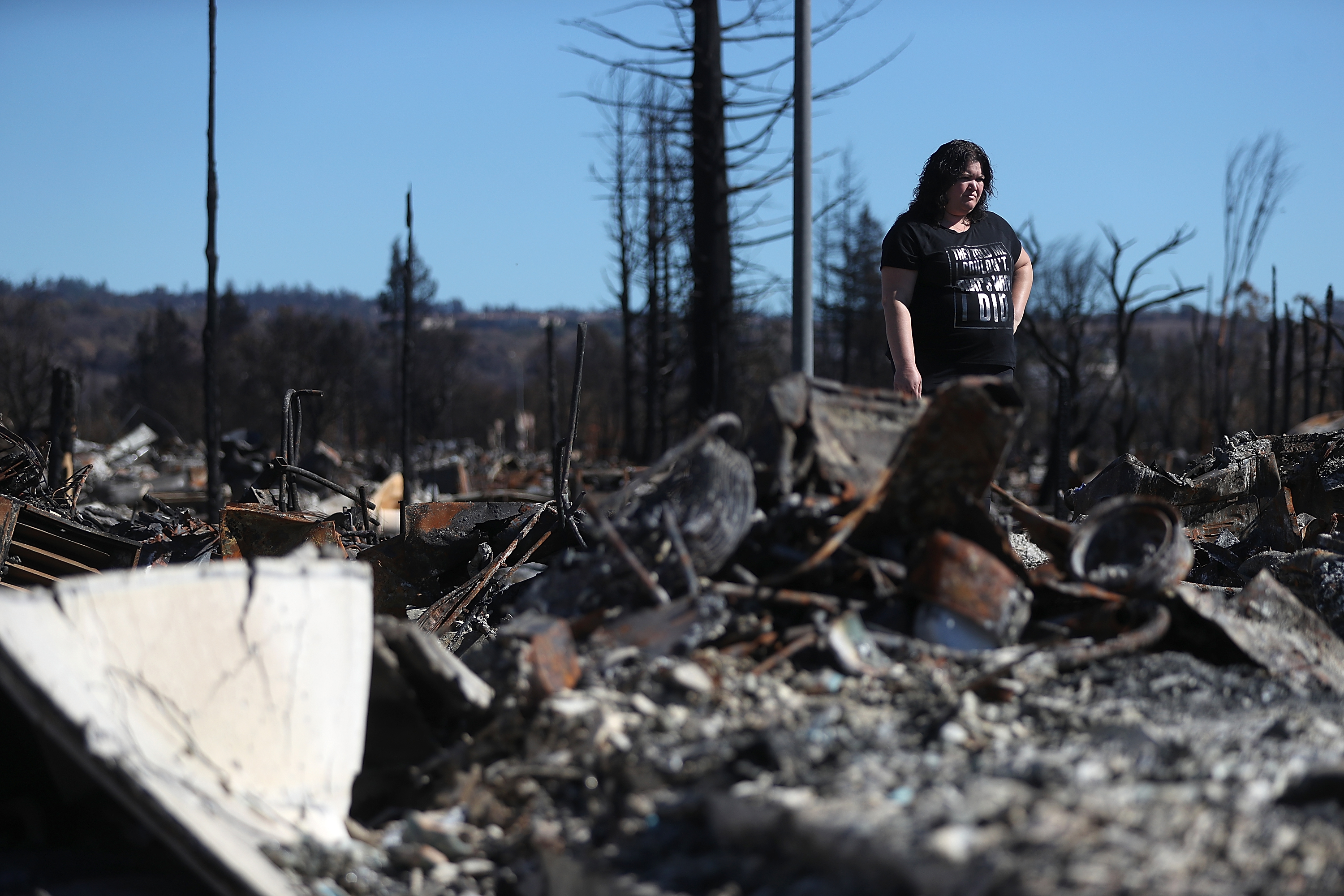 Renee Hernandez looks over the remains of her Coffey Park home that was destroyed by the Tubbs Fire, on Oct. 23, 2017 in Santa Rosa. (Credit: Justin Sullivan / Getty Images)