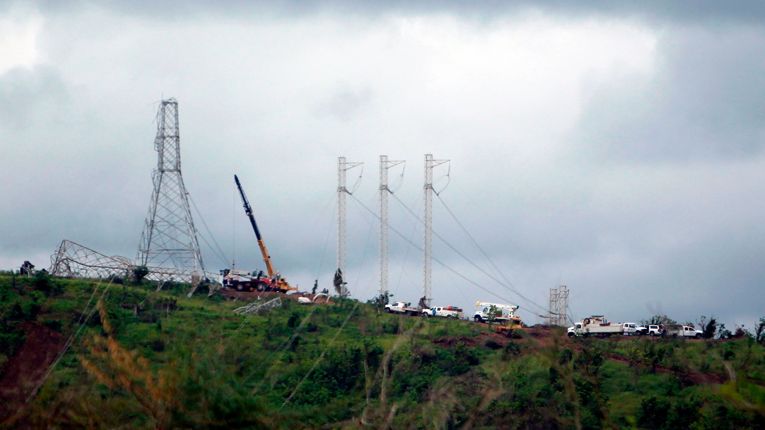 Workers restore high tension power lines damaged by Hurricane Maria in Guayama, Puerto Rico, on Oct. 28, 2017. (Credit: Ricardo Arduengo / AFP / Getty Images)