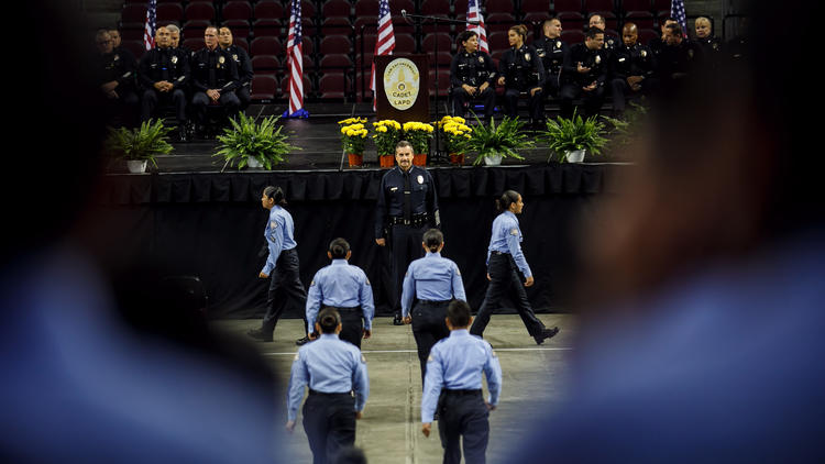 Cadets file past Police Chief Charlie Beck for inspection before their graduation ceremony at USC's Galen Center in June, 2017. (Credit: Marcus Yam / Los Angeles Times)