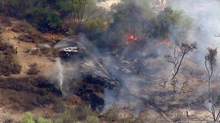 Fire crews battle a blaze in the Hansen Dam Recreation Area on Oct. 25, 2017. (Credit: Sky5 / KTLA)