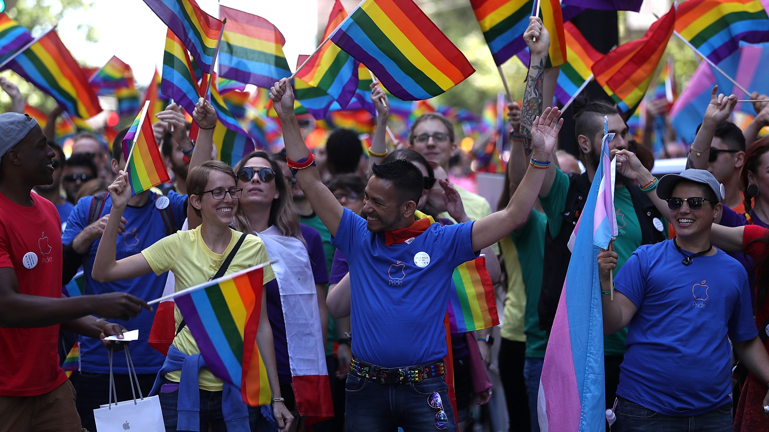 Parade participants wave pride flags during the 2016 San Francisco Pride Parade on June 26, 2016. (Credit: Justin Sullivan / Getty Images)