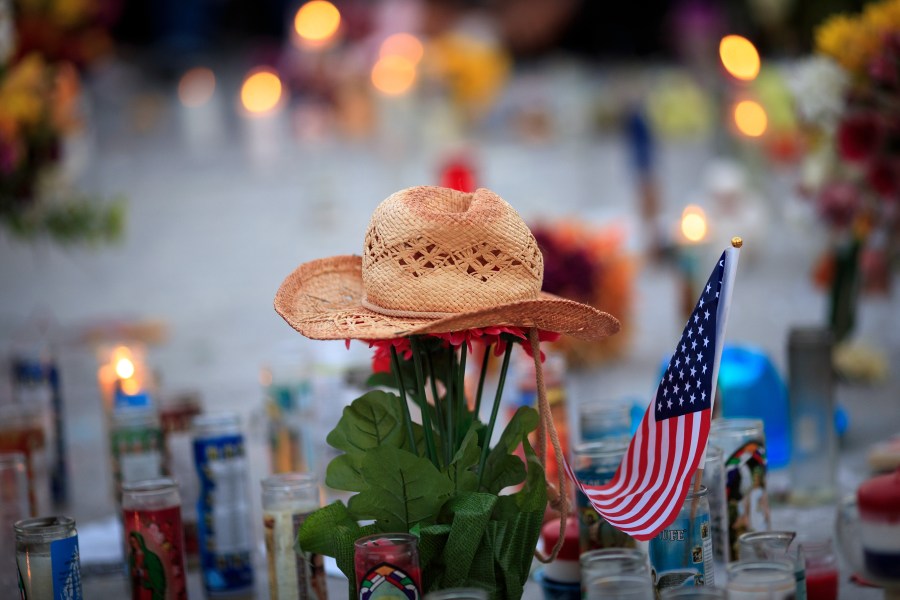 A hat is left at a makeshift memorial during a vigil to mark one week since the mass shooting at the Route 91 Harvest country music festival, on the corner of Sahara Avenue and Las Vegas Boulevard at the north end of the Las Vegas Strip, on Oct. 8, 2017. (Credit: Drew Angerer / Getty Images)