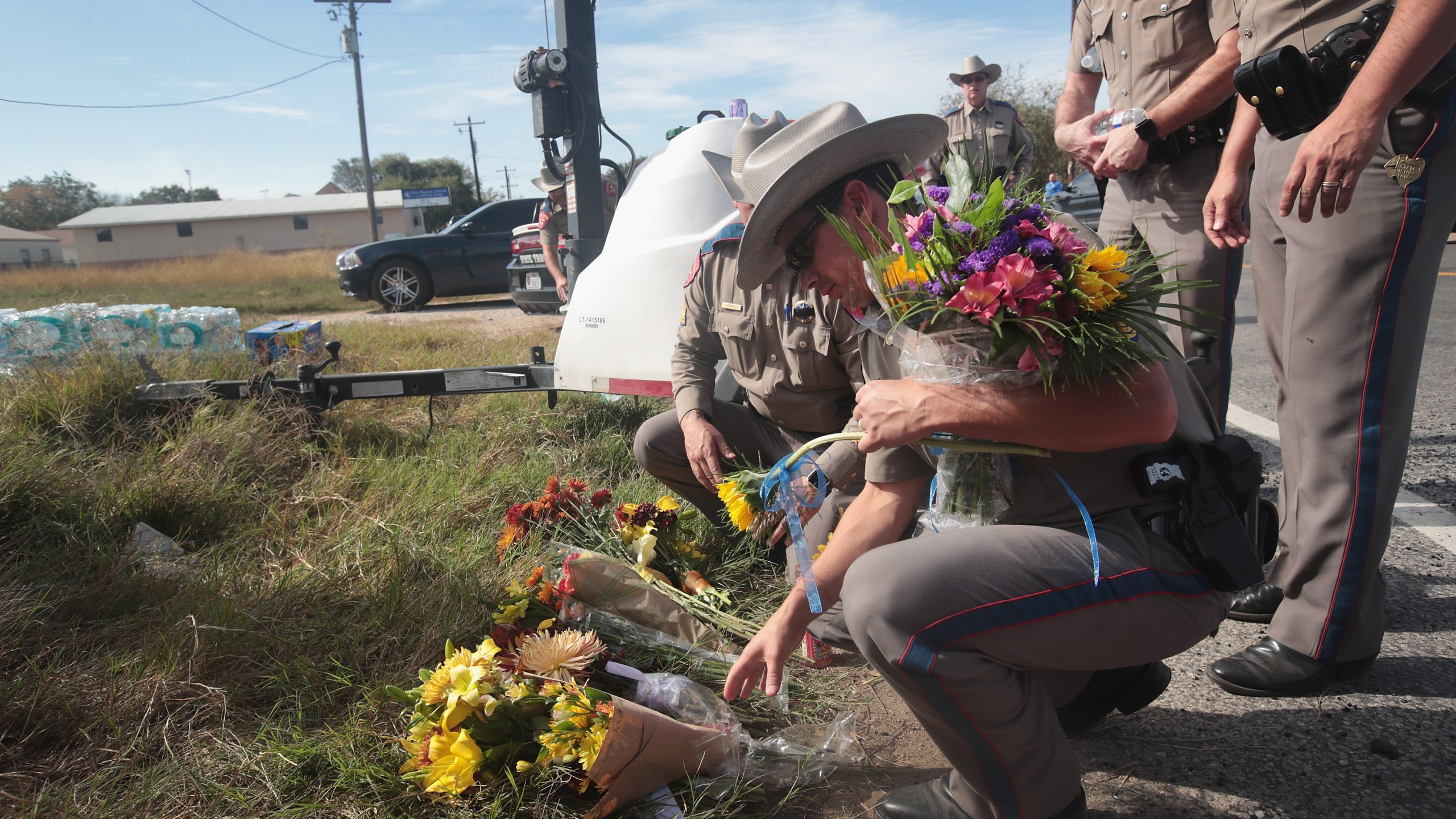 Police move flowers placed at a barricade near the First Baptist Church of Sutherland Springs on Nov. 6, 2017. in Sutherland Springs, Texas. (Credit: Scott Olson/Getty Images)