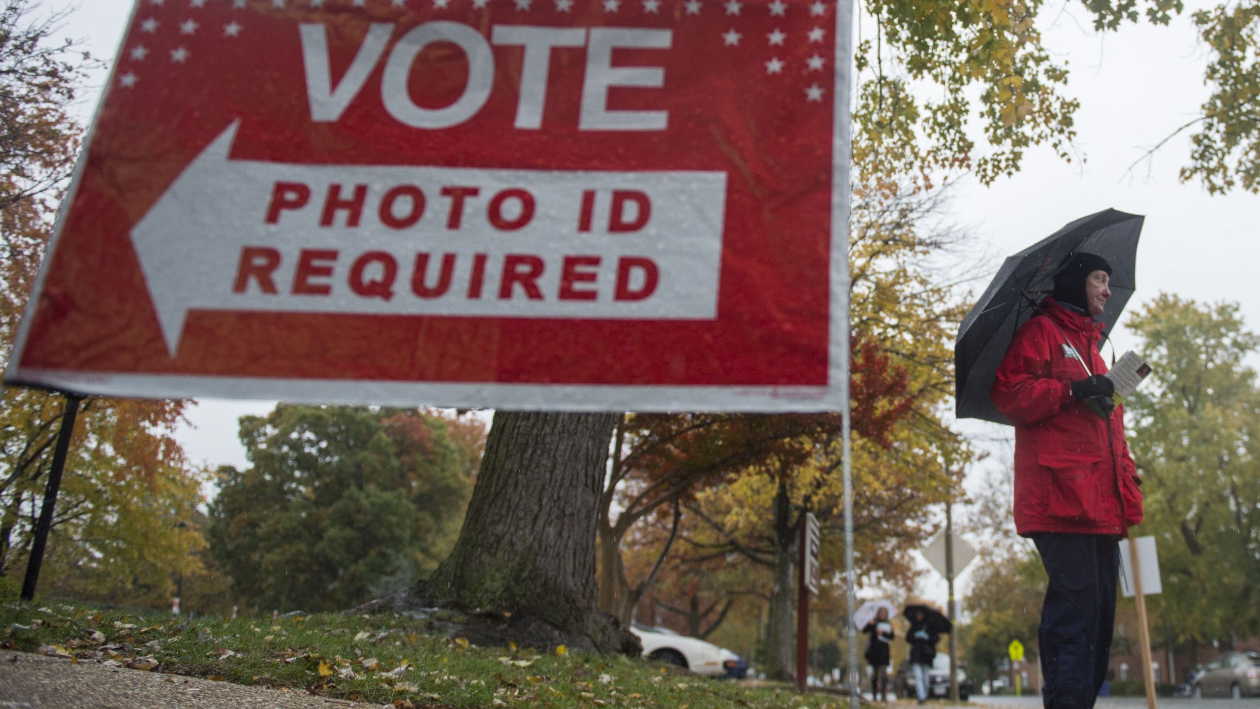 A volunteer for the Independent political party stands outside a polling station waiting to speak to voters in Arlington, Virginia, on Nov. 7, 2017. (Credit: ANDREW CABALLERO-REYNOLDS/AFP/Getty Images)