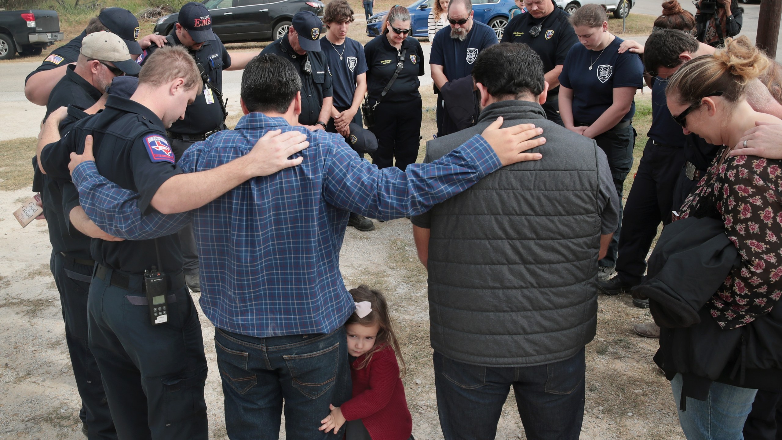 First responders share a prayer following a Veterans Day ceremony outside the community center in Sutherland Springs, Texas, on Nov. 11, 2017. (Credit: Scott Olson / Getty Images)