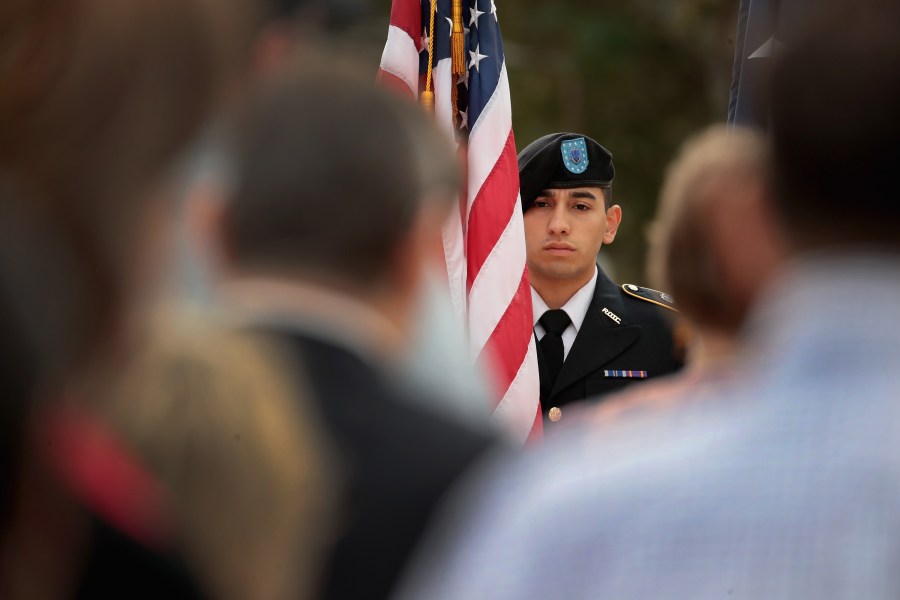 Joshua Tinajero holds colors during a Veterans Day ceremony outside the community center in Sutherland Springs, Texas, on Nov. 11, 2017. (Credit: Scott Olson / Getty Images)