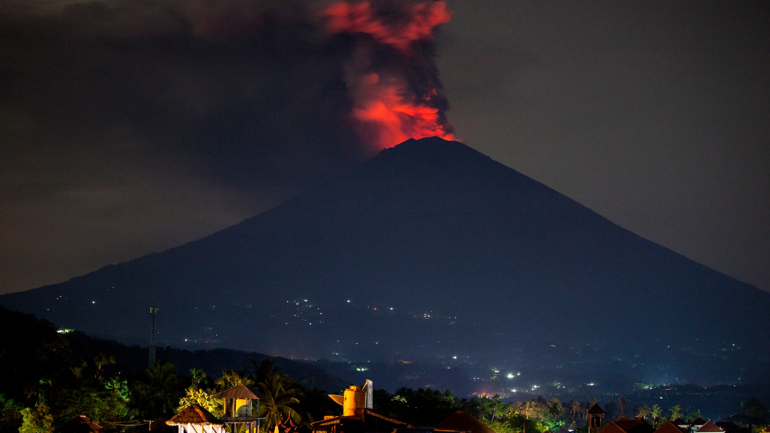 Mount Agung spews volcanic ash into the sky at night on Nov. 27, 2017, in Karangasem, Bali, Indonesia. (Credit: Andri Tambunan/Getty Images)