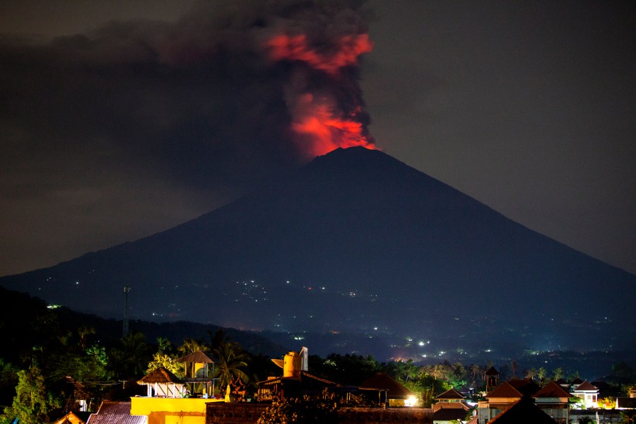 Mount Agung spews volcanic ash into the sky at night on Nov. 27, 2017, in Karangasem, Bali, Indonesia. (Credit: Andri Tambunan/Getty Images)