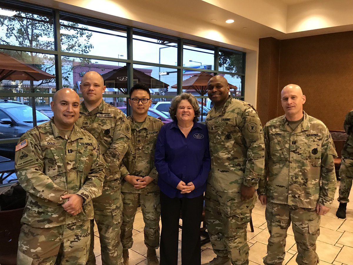 Betty Porto is shown flanked by veterans in this photo tweeted by Porto's Bakery on Nov. 10, 2017.