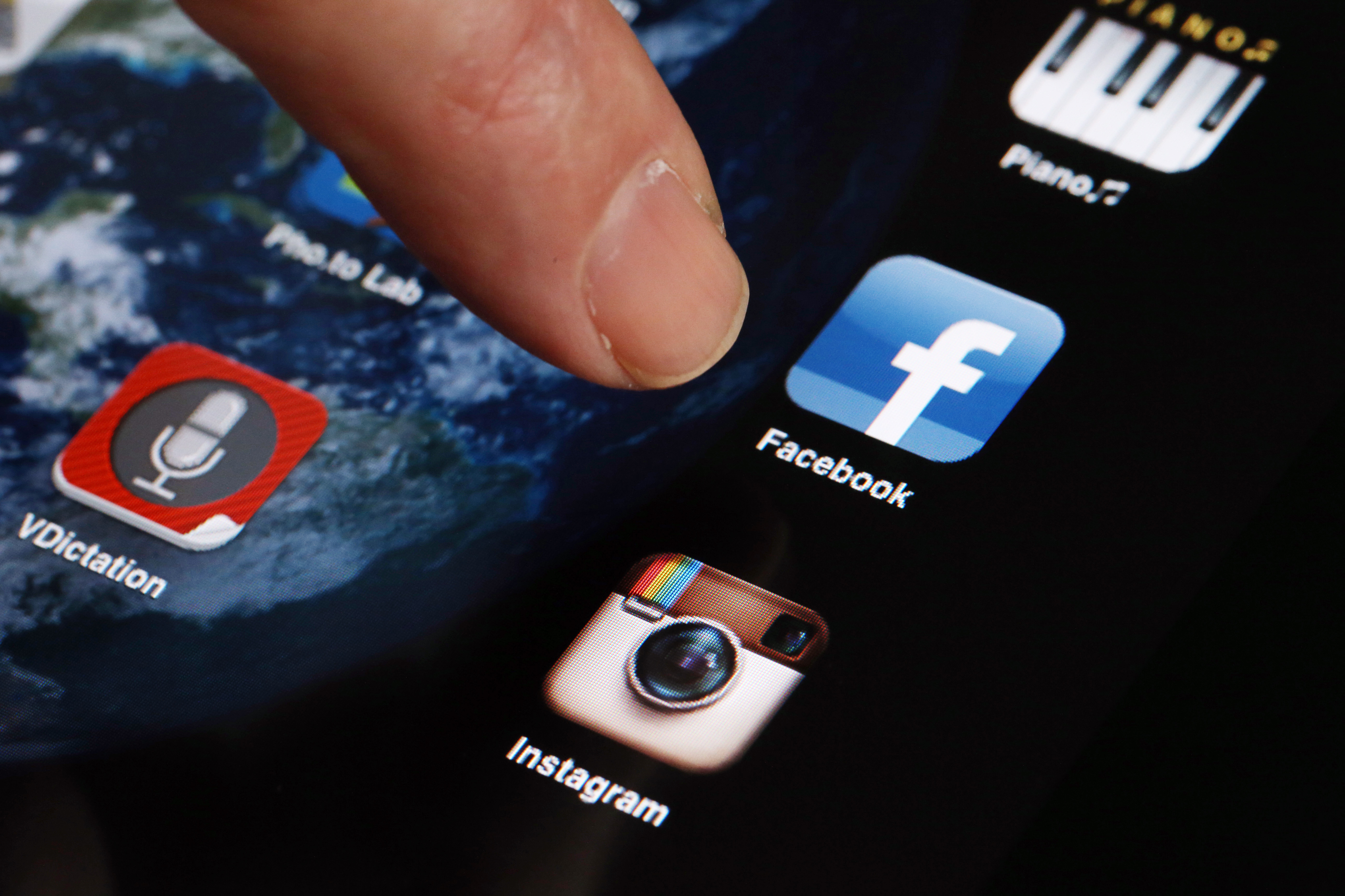 A man shows the Instagram icon on a phone on April 10, 2012. (Credit: THOMAS COEX/AFP/Getty Images)